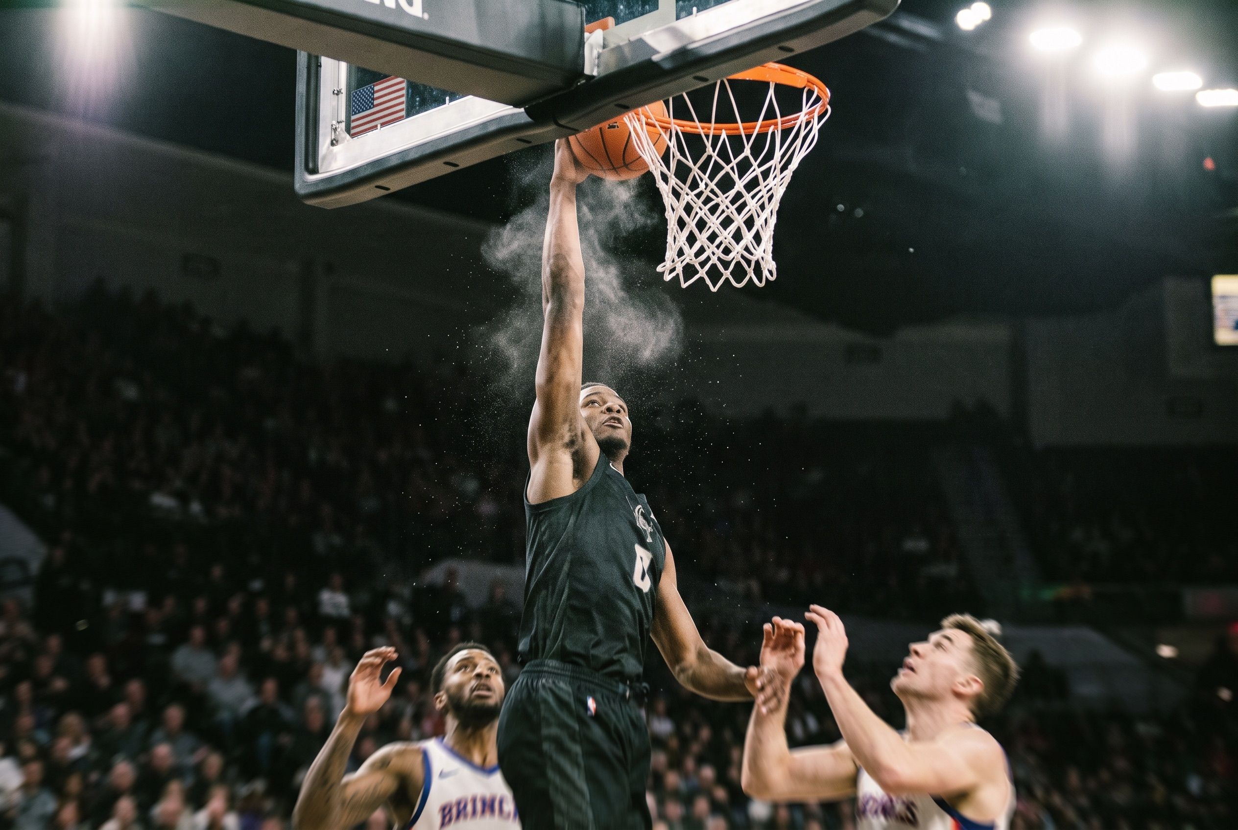 A basketball player at the top of a dunk, arms extended above the rim, arena lights behind him